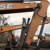 A tracked excavator working in the field that Reed's services