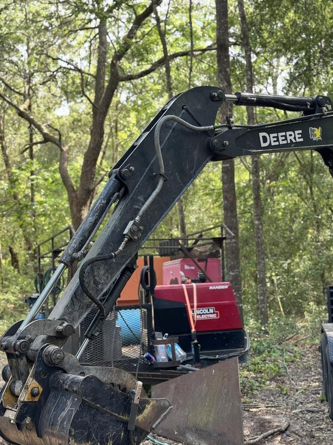 John Deere forestry machine repaired on-site at a wood lot