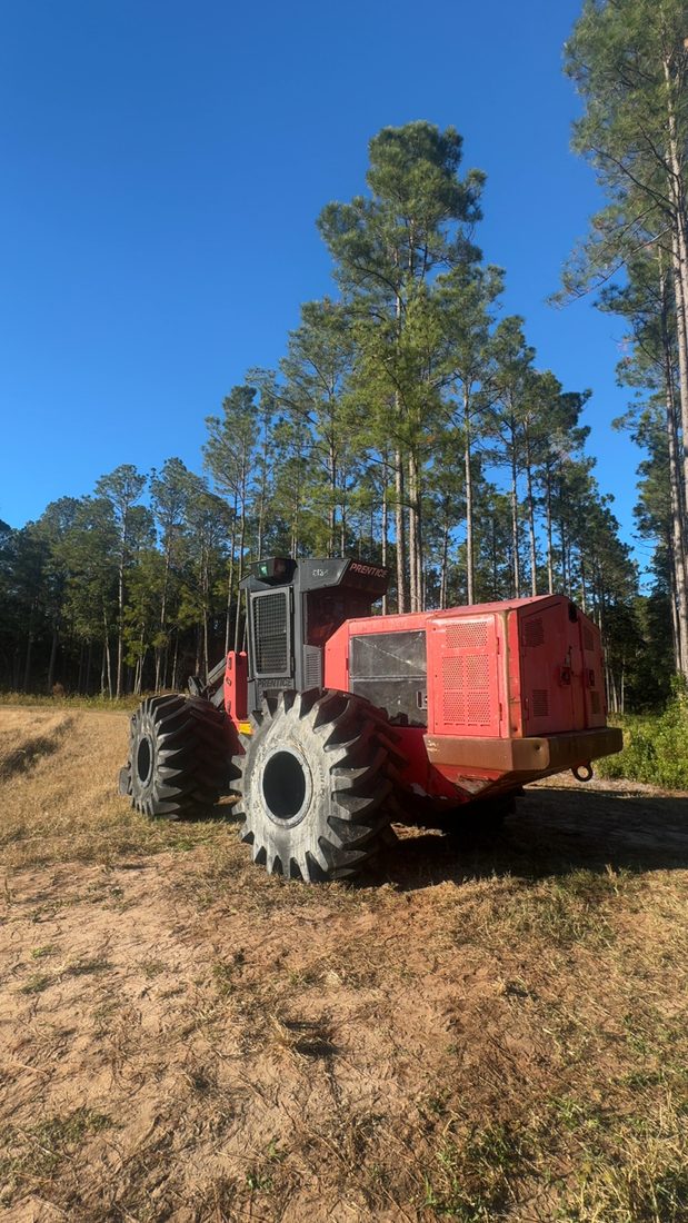 A forestry machine at the tree line