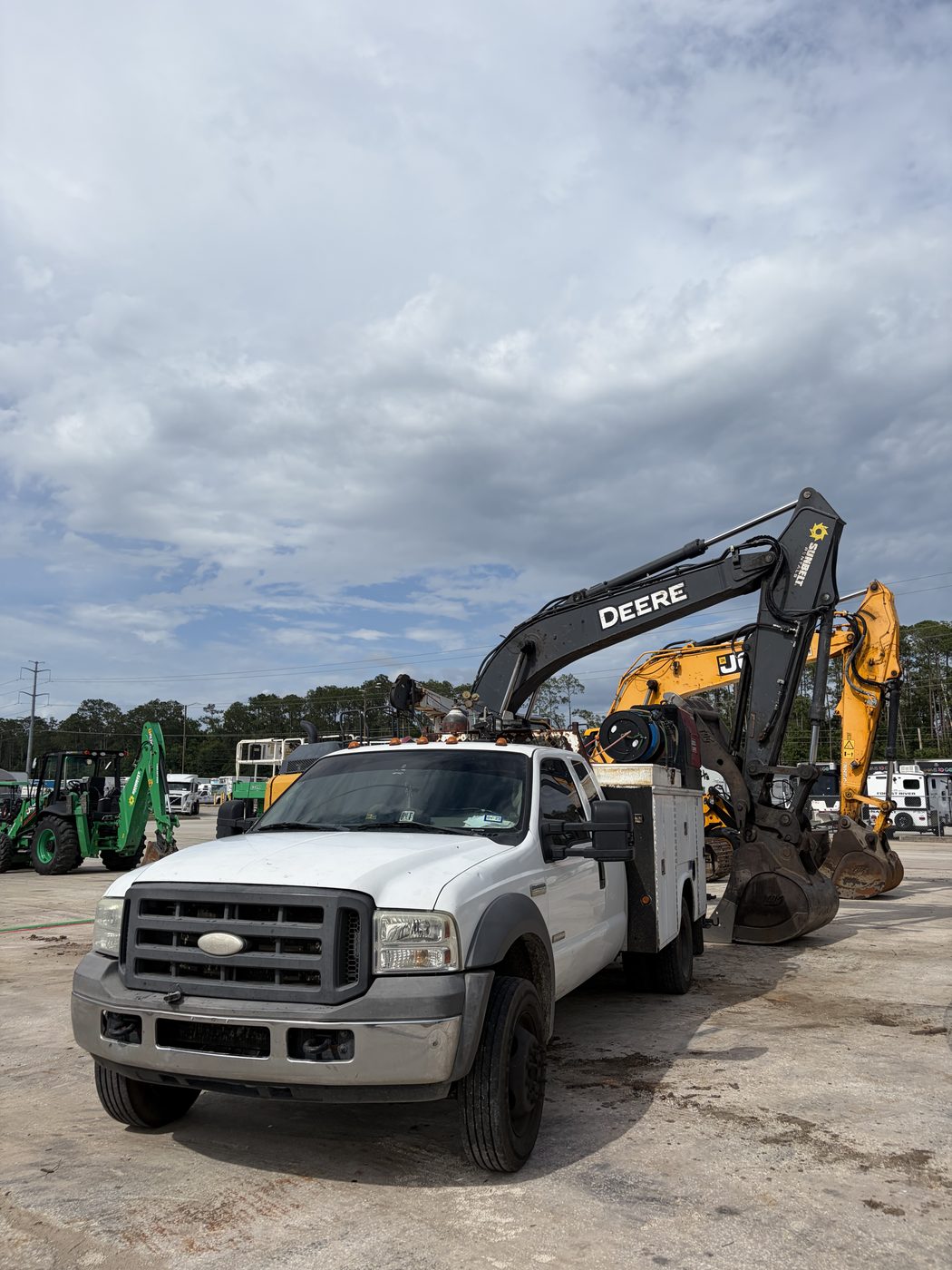 Our service truck on a job site with heavy equipment