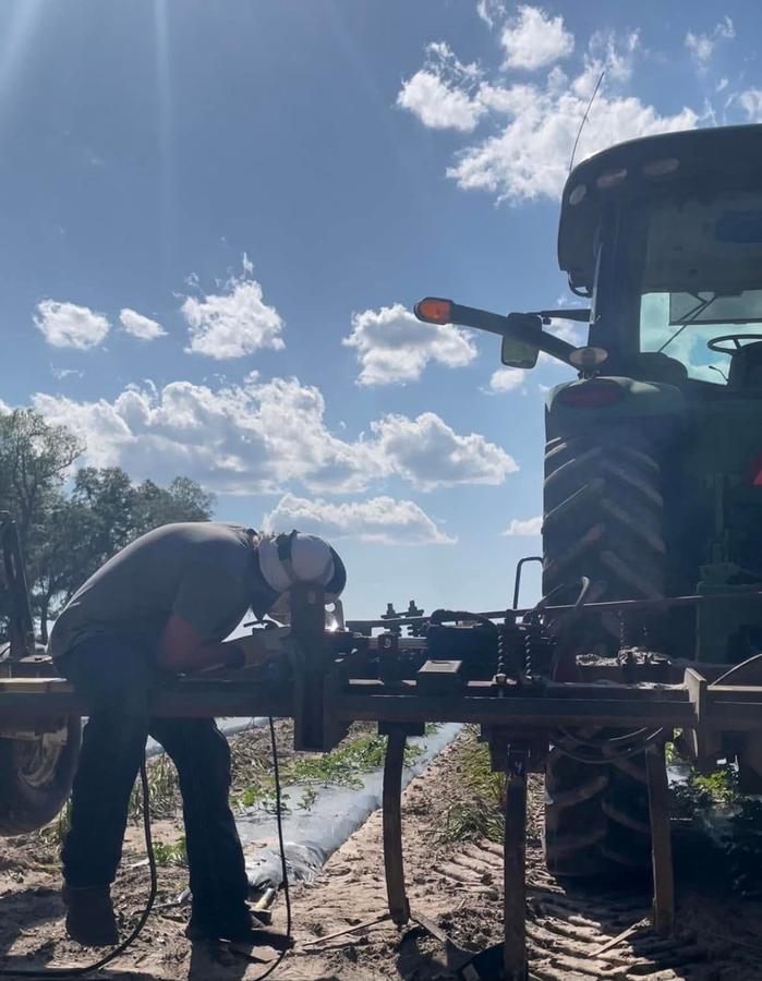 Tyler Reed, owner of Reed's Mobile Services, working on a machine